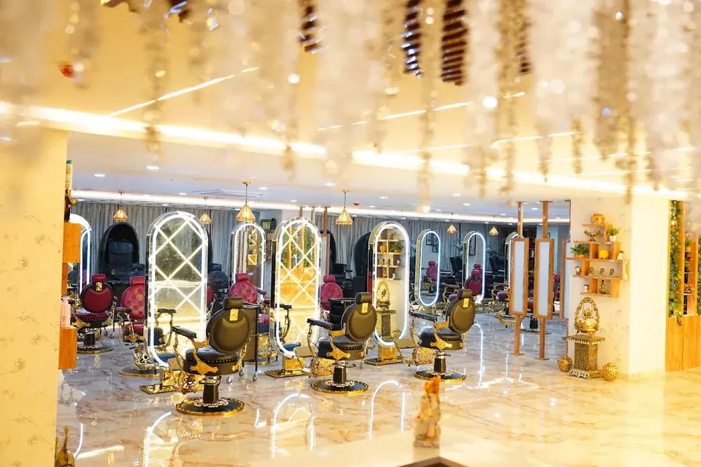 The styling hall at Hiwaga Gachibowli, with lit mirrors under a floral ceiling